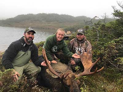 Three hunters with prize Moose